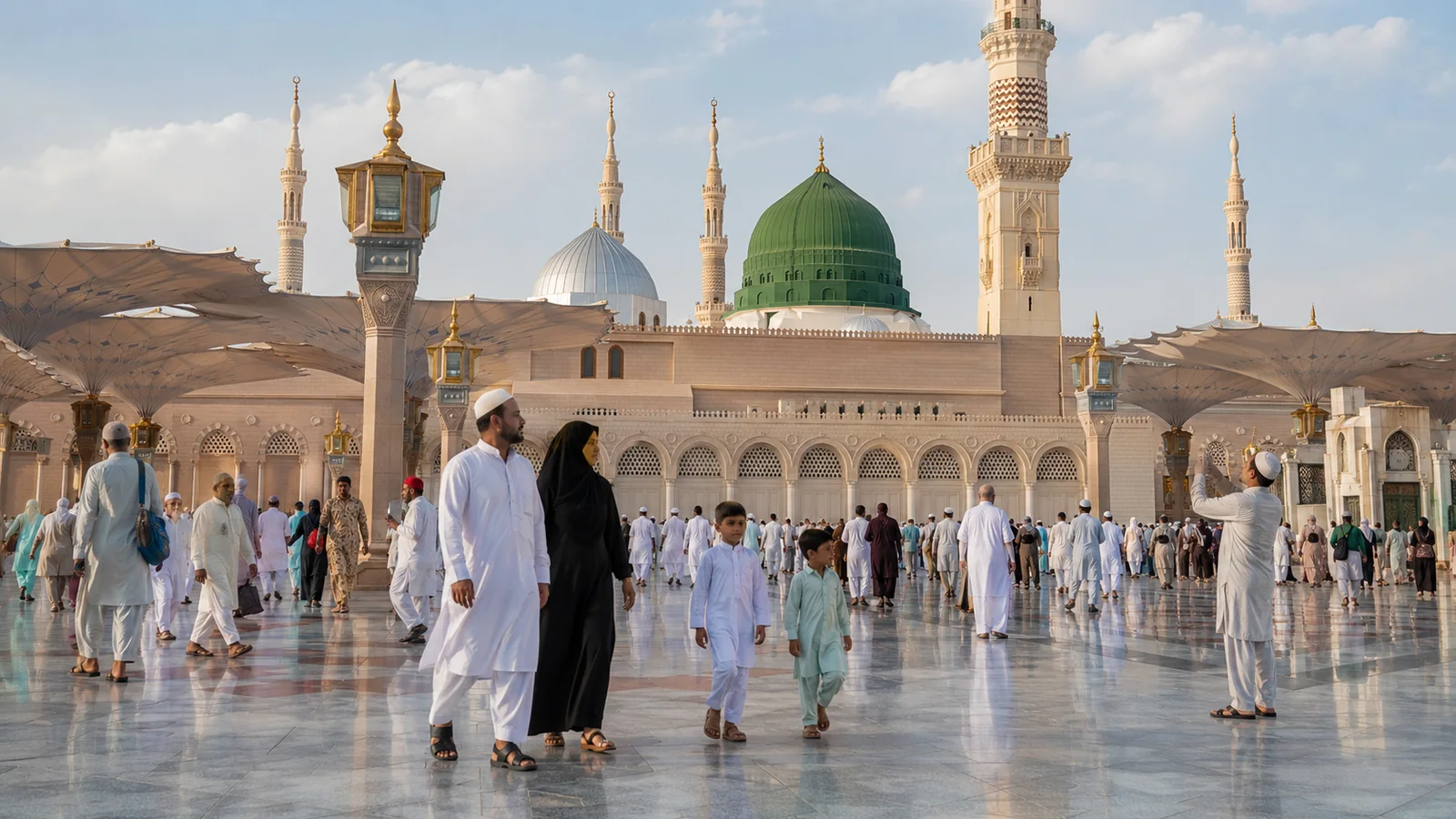 Pilgrims walking in the courtyard of Masjid an-Nabawi in Madinah.
